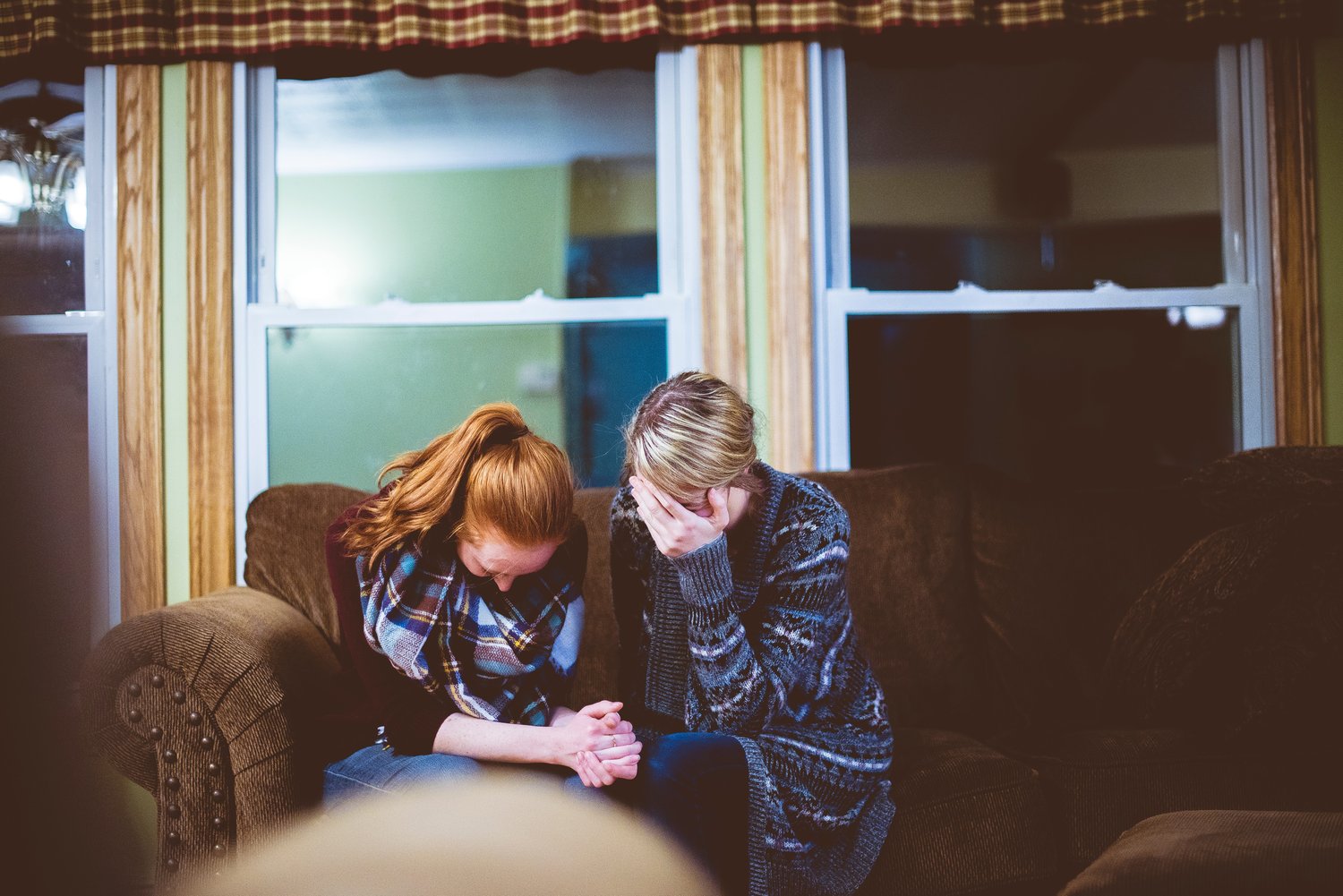 mentor praying for student in counseling session