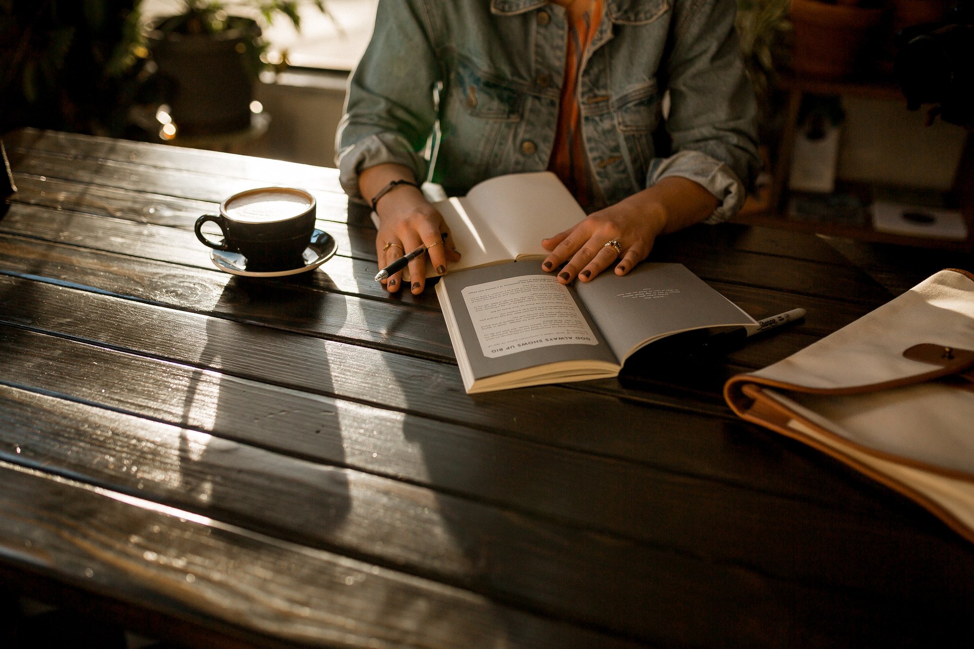 YWAMER sitting at a table journalling - by david-iskander